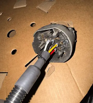 Vehicle wiring passing through a rubber grommet